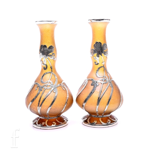 110A - A pair of early 20th Century Loetz (Attributed) glass vases of footed mallet form with swollen necks... 