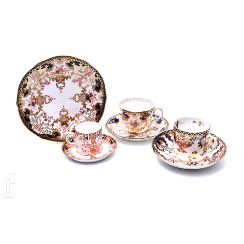 99A - A Royal Crown Derby 3788 pattern trio, of fluted form, decorated wth gilt heightened flower filled b... 