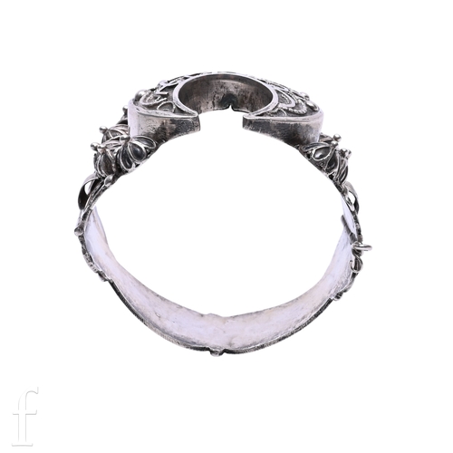 52 - A foreign silver bangle, with scroll and moulded decoration, integral clasp, total weight 63.4g, inn... 