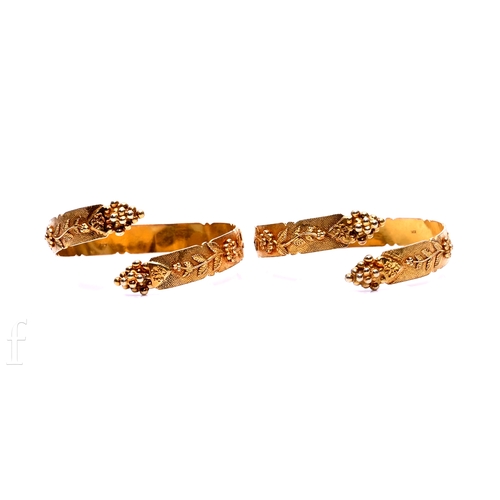 99 - A pair of gold bangles, with foliate detail against a textured ground, total weight 65g.