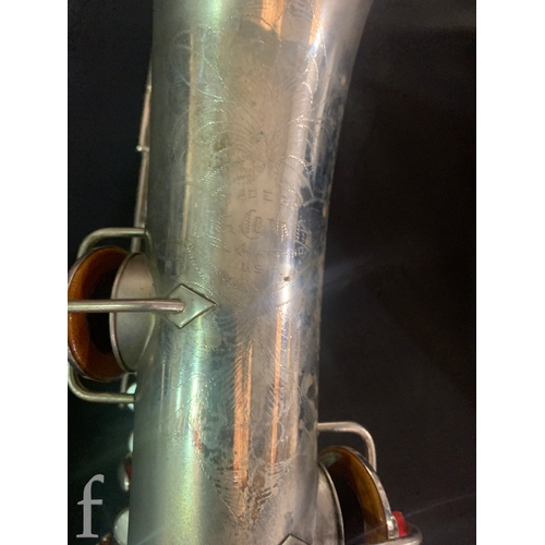 472 - A 20th Century or earlier nickel plated saxophone No 111892, length 62cm, in fitted plush lined case... 