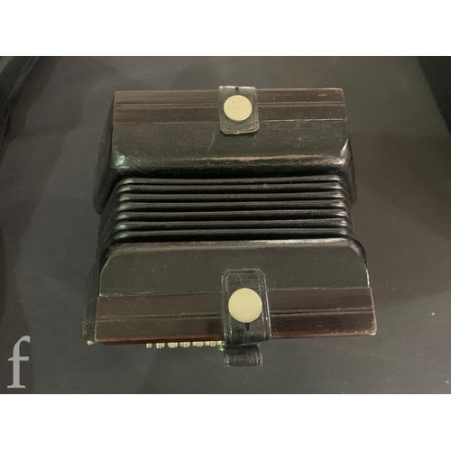 480 - A late 19th to early 20th Century octagonal cased concertina, thirty two button operation, in pine c... 