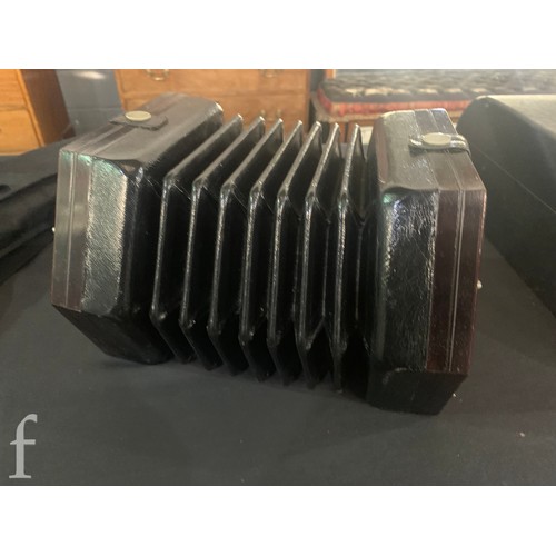 480 - A late 19th to early 20th Century octagonal cased concertina, thirty two button operation, in pine c... 