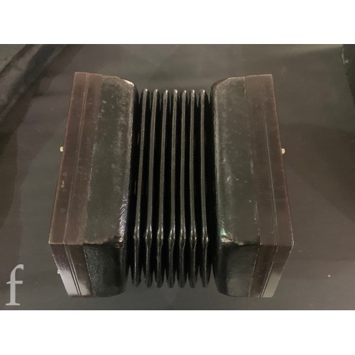 480 - A late 19th to early 20th Century octagonal cased concertina, thirty two button operation, in pine c... 