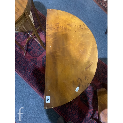 726 - A small 20th Century French mahogany demi-lune side cabinet, fitted with three drawers and gilt meta... 