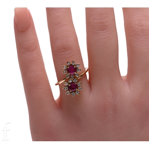 121 - A ruby and diamond ring, the double clusters set on a cross over mount, above a plain band, hallmark... 