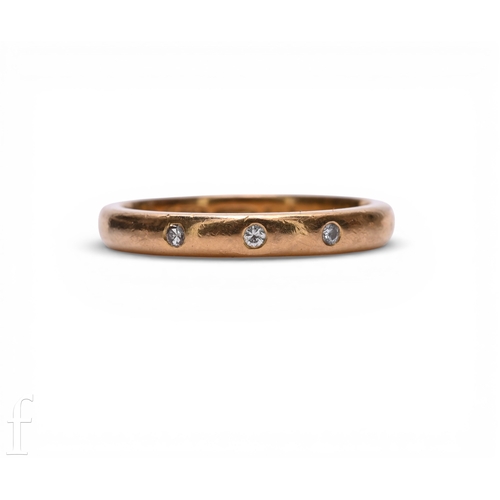 122 - A 22 carat gold and diamond band, inset with three circular-cut diamonds, hallmarked for 22 carat go... 