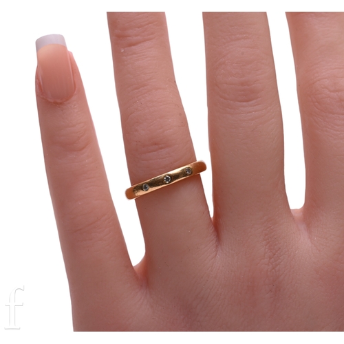 122 - A 22 carat gold and diamond band, inset with three circular-cut diamonds, hallmarked for 22 carat go... 
