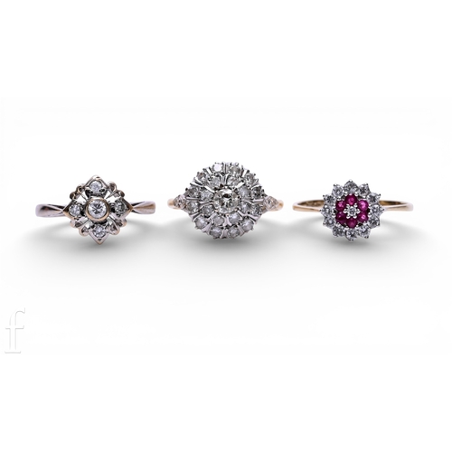 124 - A diamond cluster ring, of tiered design, marked '18CT', total weight 3g, ring size L1/2, a diamond ... 