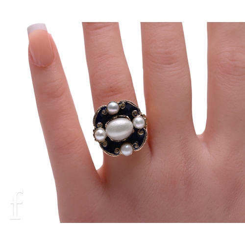 1 - An enamel and cultured pearl ring, the blue enamel mount with gold scroll detail to the edges, later... 