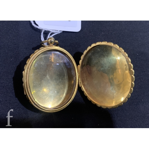 12 - A Victorian locket, circa 1860, the oval locket with two hinged covers, one glass locket insert lack... 