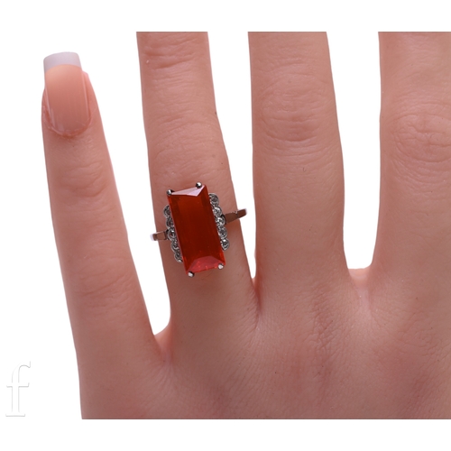 181 - Liberty & Co; a fire opal ring, circa 1900, the step-cut fire opal, four claw set between diamon... 