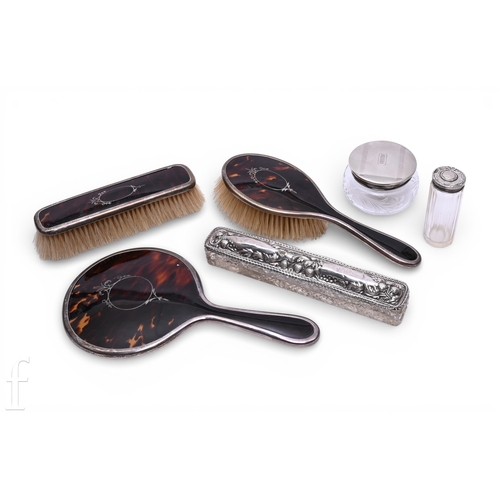 519 - A George V silver mounted tortoiseshell three piece dressing table set, Birmingham 1923, and three s... 