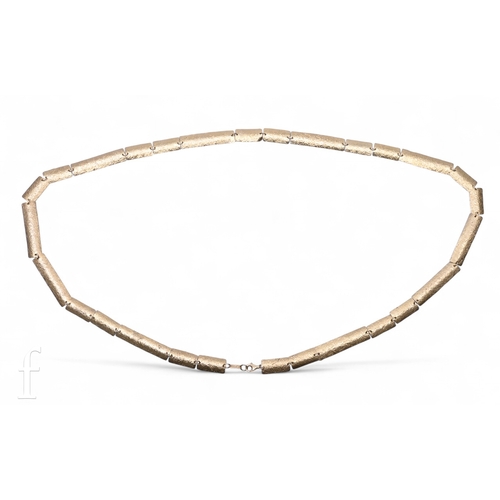 163 - A silver gilt necklace composed of twenty seven oblong textured plaques, with bolt ring clasp, marke... 
