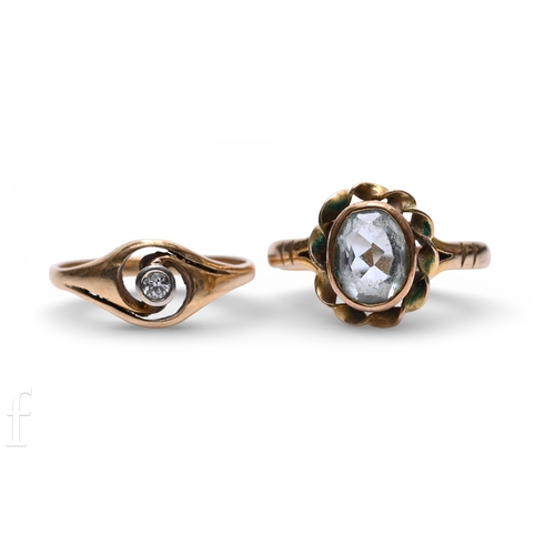 137 - An aquamarine ring, the oval mixed-cut aquamarine collet set within a rope work border, between pier... 