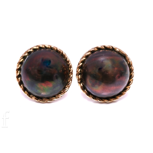 165 - A pair of black mabe pearl and gold earrings, set within a ropework border, post and butterfly fitti... 