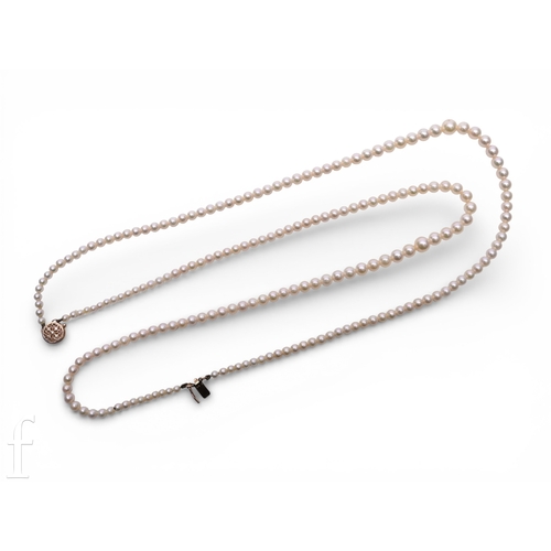 166 - A cultured pearl necklace, the two graduating rows of cultured pearls on a circular pierced clasp, m... 
