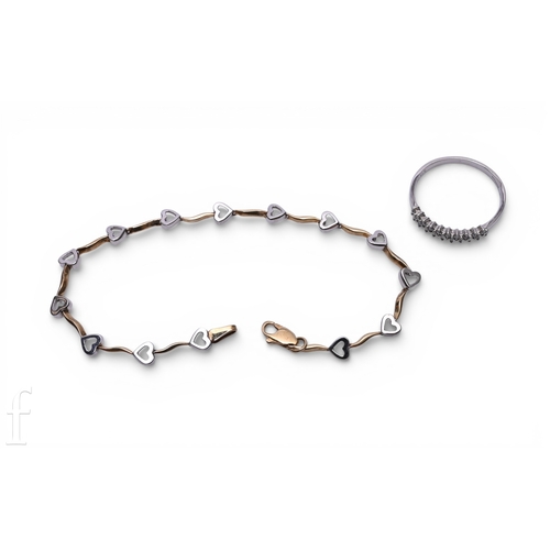 202 - A two colour bracelet, of alternate heart and wavy bar design, marked '9K', total weight 3.8g, 17.3c... 