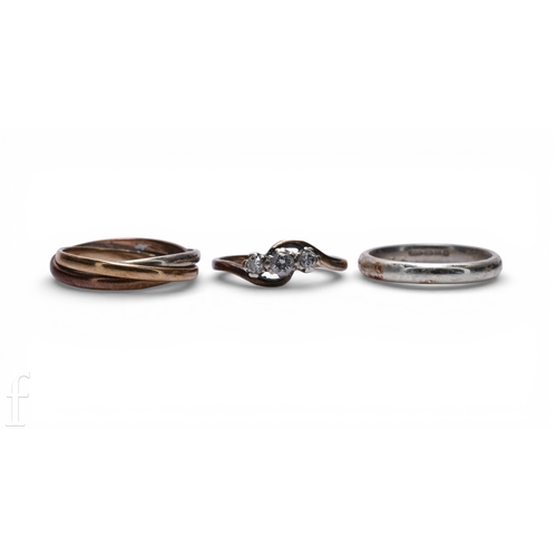 146 - A three stone diamond ring, the eight-cut diamonds graduating in size and illusion set, total weight... 