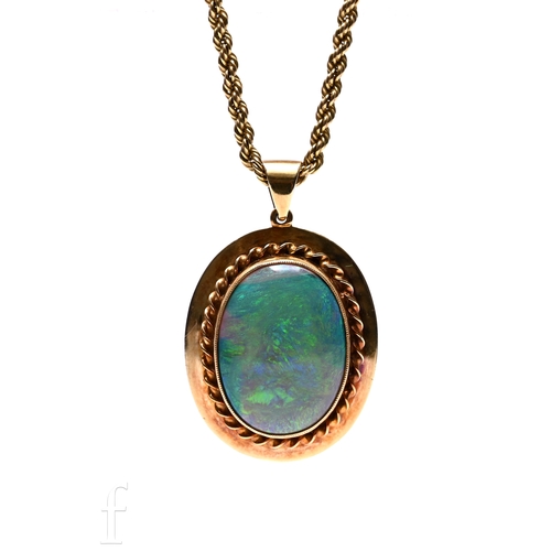 170 - A black opal pendant, the oval cabochon-cut opal within a rubover mount with rope work detail, on a ... 