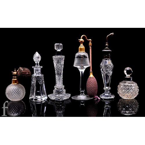 451 - A small assorted collection of early 20th Century clear cut crystal scent bottles to include cut and... 