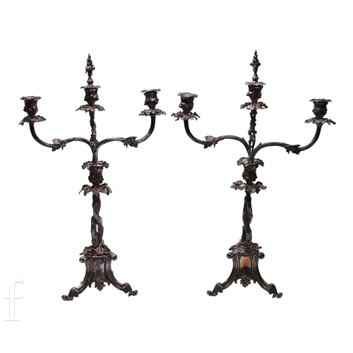 566 - A pair of Victorian Elkington silver plate vine pattern three branch candelabra, the pendestal trifo... 