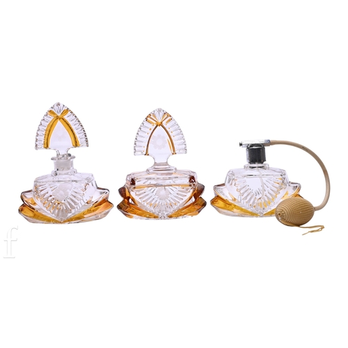 425 - A pair of Bohemian Art Deco flashed amber over clear glass scent bottles, each with wheel cut flower... 