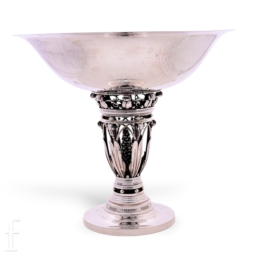 Johan Rohde - Georg Jensen - An early 20th Century silver 'Queen's Bowl' centrepiece 250B, circa 1925-1932, the wide hand raised planished circular bowl on openwork column with vertical stepped bands supported by foliate scroll straps and arcaded tendrils, enclosing central naturalistic seed head, on circular terraced foot and circular base, impressed marks, height 32cm, 84.89ozt.