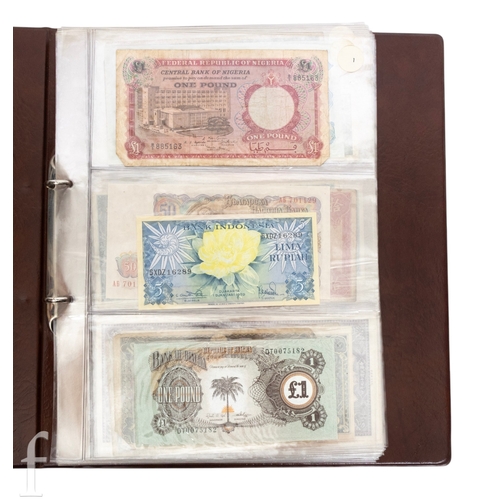 48 - Banknotes - An album of assorted world notes to include a 1965 Nigerian one pound note, Bulgarian St... 