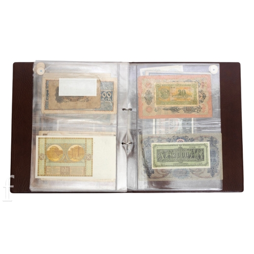 48 - Banknotes - An album of assorted world notes to include a 1965 Nigerian one pound note, Bulgarian St... 