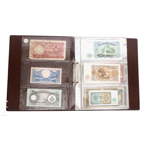 48 - Banknotes - An album of assorted world notes to include a 1965 Nigerian one pound note, Bulgarian St... 