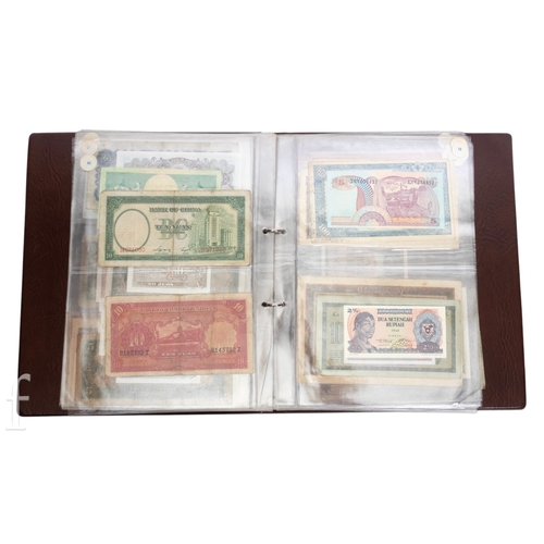 49 - Banknotes - An album of assorted world notes to include a 1965 Nigerian one pound note, Bulgarian St... 