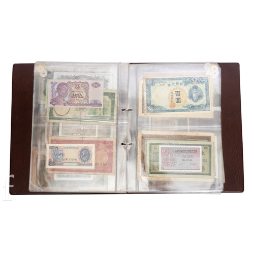 49 - Banknotes - An album of assorted world notes to include a 1965 Nigerian one pound note, Bulgarian St... 
