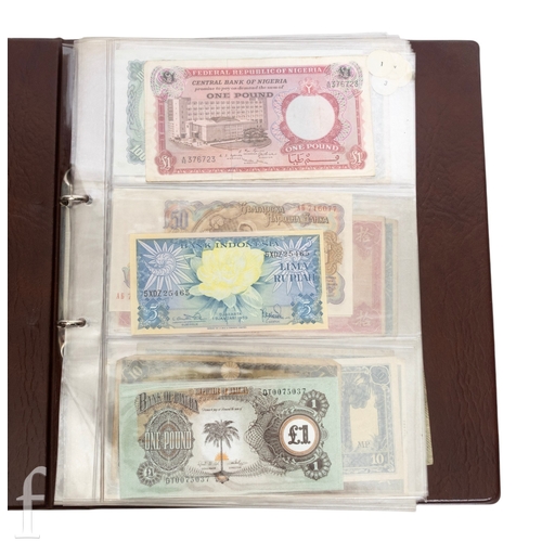 49 - Banknotes - An album of assorted world notes to include a 1965 Nigerian one pound note, Bulgarian St... 