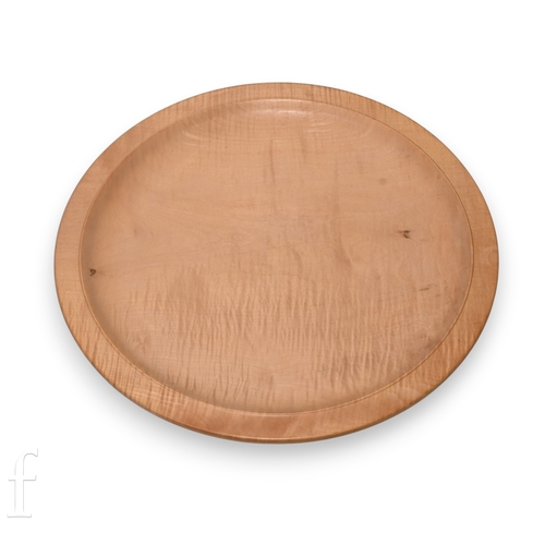 373 - A late 20th Century fiddleback sycamore circular platter of plain form, initialled to the reverse JS... 