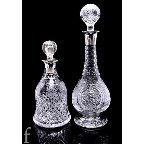 690 - A cut glass and silver collared wine decanter and stopper of bell form decorated with vine leaves an... 