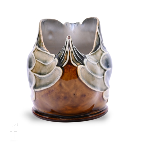837 - A Doulton Lambeth stoneware spoon warmer designed by Mark V. Marshall, modelled as a stylised seated... 