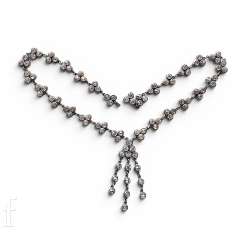 118 - A paste necklace, circa 1920-30, the necklace composed of trefoils of white paste collets suspending... 