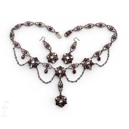 109 - An Austro Hungarian garnet and mother of pearl necklace, circa 1880, of festoon design set in silver... 