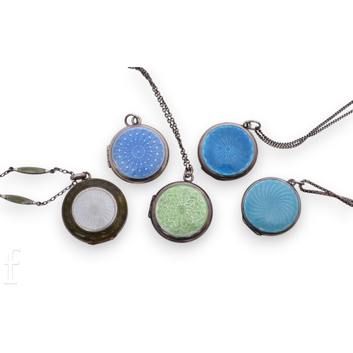 86 - Five white metal and enamelled pendant lockets, of circular form, with four fancy link chains, total... 