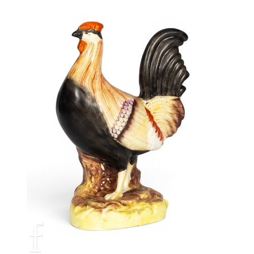 803 - A mid 19th Century Staffordshire figure of a rooster, circa 1850s, modelled standing on naturalistic... 