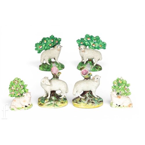 808 - A pair of 19th Century Staffordshire sheep, each modelled standing before bocage trees on open domed... 