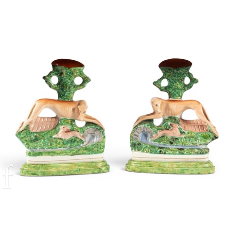 822 - A pair of 19th Century Staffordshire chimney ornaments, each modelled as a coursing hound and rabbit... 