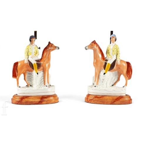823 - A pair of 19th Century Staffordshire chimney ornaments, each modelled as a horse and jockey, in raci... 