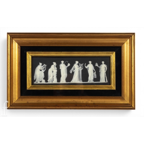 918A - A Wedgwood Pottery black Japserware plaque, depicting six classical figures in white relief, framed,... 