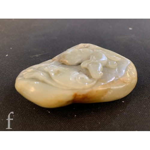 1291 - A Chinese green hardstone pebble carving of a horse under lotus flower, the polished stone carved in... 