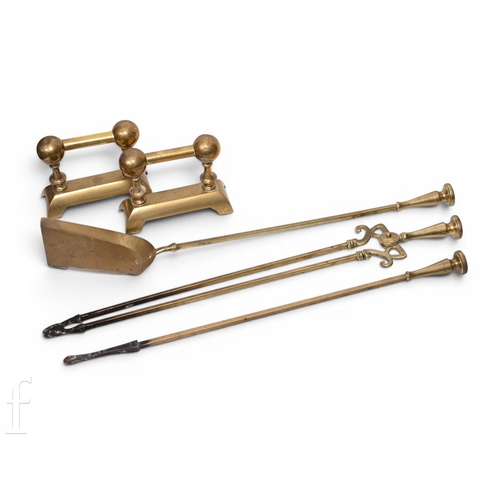 1313 - A set of three brass fire irons and a pair of dogs. (5)