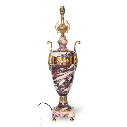 1360 - A 20th Century French gilt metal applied marble urn in the classical style, leaf cast handles on a s... 
