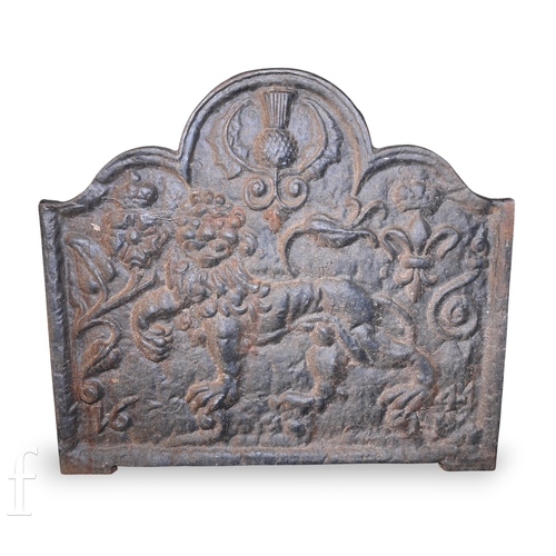 1401 - A cast iron fireback depicting a rampant lion below a thistle and flanked by a rose and a fleur de l... 