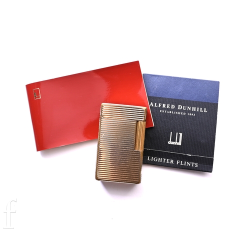 1403 - A late 20th Century French gold plated cigarette lighter by S.J. Dupont, Paris, with ribbed body and... 